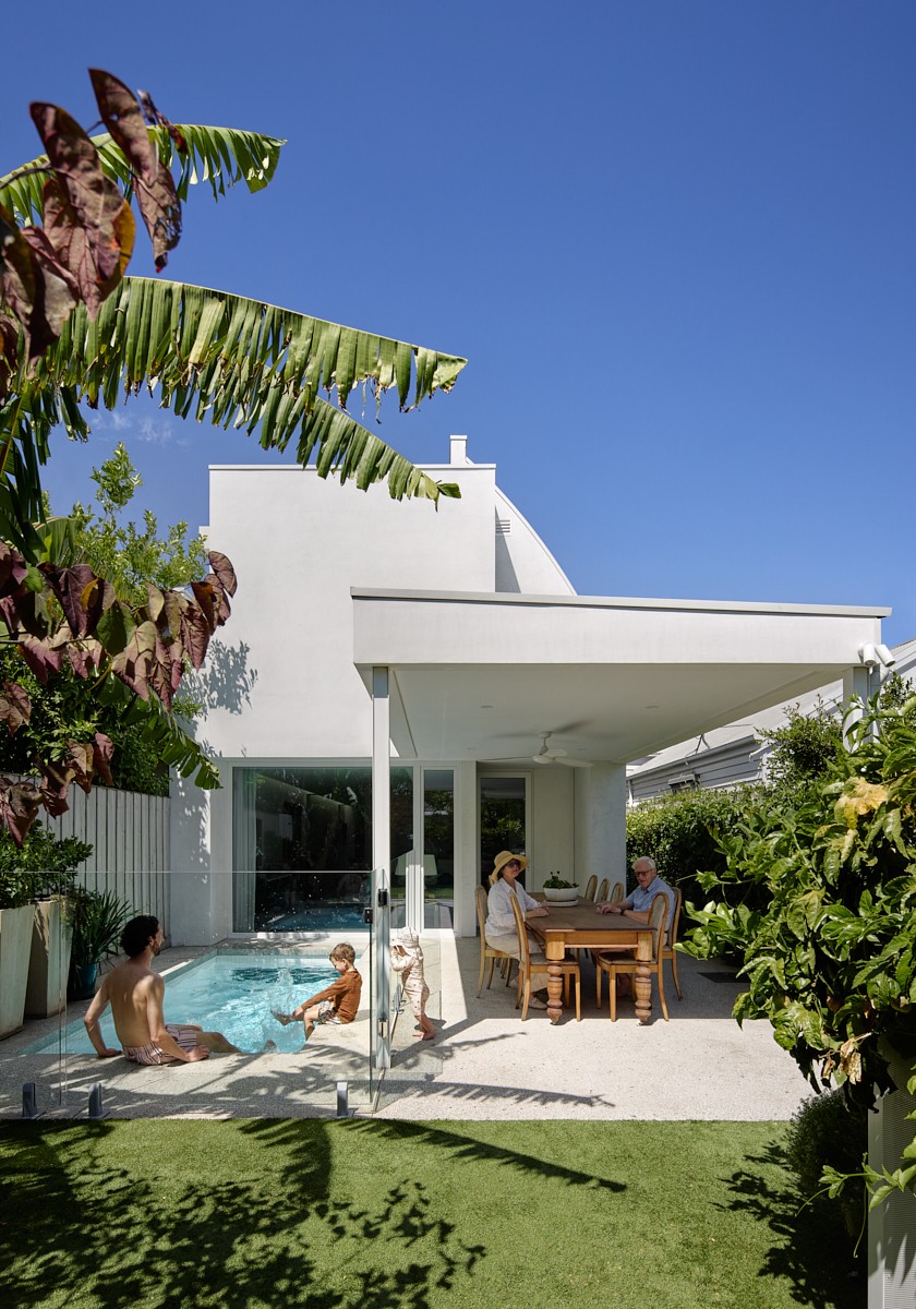 Family outdoors by the pool and covered terrace